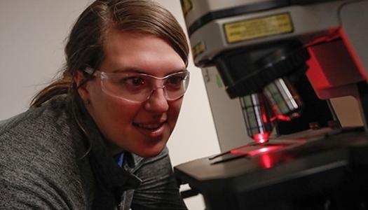 Student working with a microscope